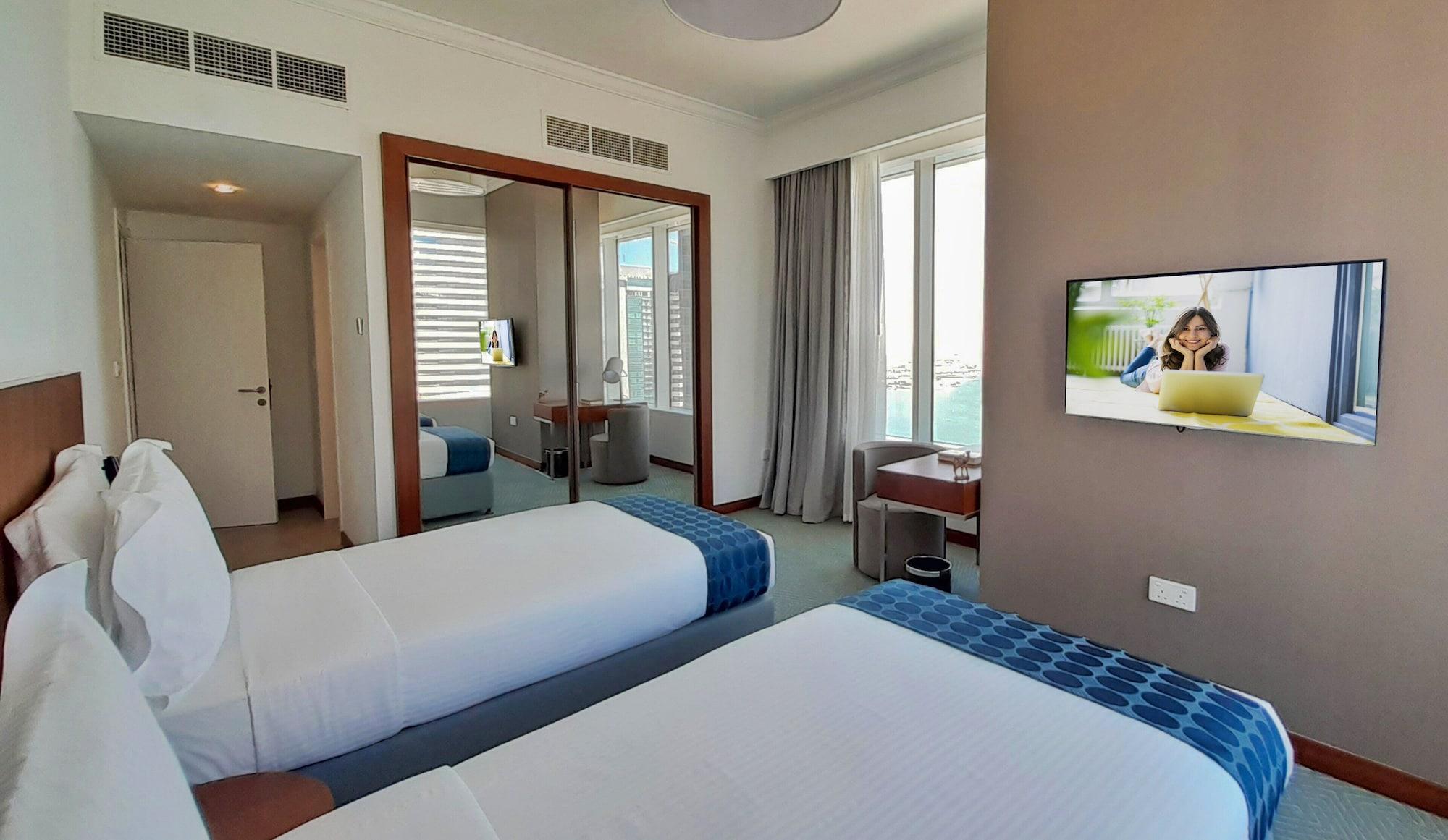 서머셋 웨스트 베이 도하 호텔 외부 사진 A bedroom at the hotel